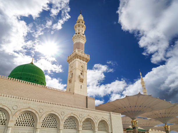 Medina, Saudi Arabia - July 07, 2020: View of cloudy blue sky at Nabawi Mosque or Prophet Mosque in Medina, Saudi Arabia. Selective focus